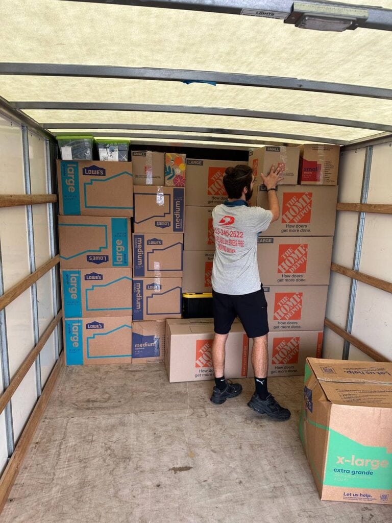 Bereket movers packing kitchen boxes with care in a Tampa Bay home